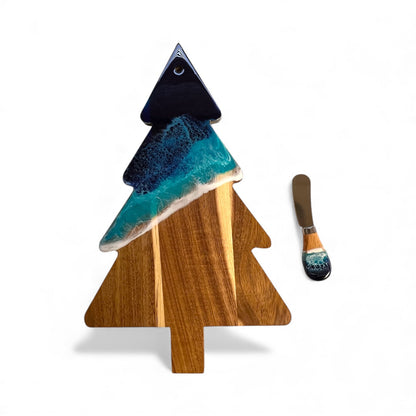 Daphnew Design Christmas tree-shaped acacia wood cheese board with blue ocean resin art and matching cheese knife.