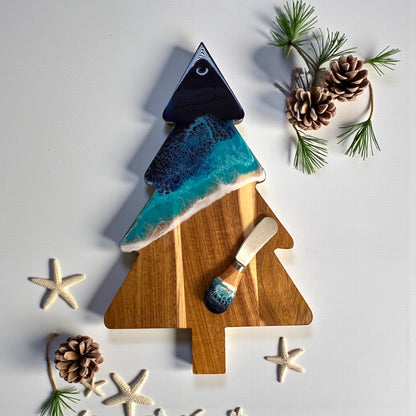 Daphnew Design Christmas tree shaped acacia wood cheese board with blue ocean resin art and matching cheese knife.